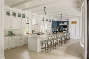 Large neutral kitchen island with ten barstools