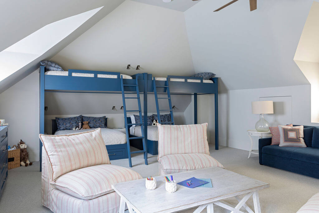 A bunk room for children with built-in custom blue bunk beds.
